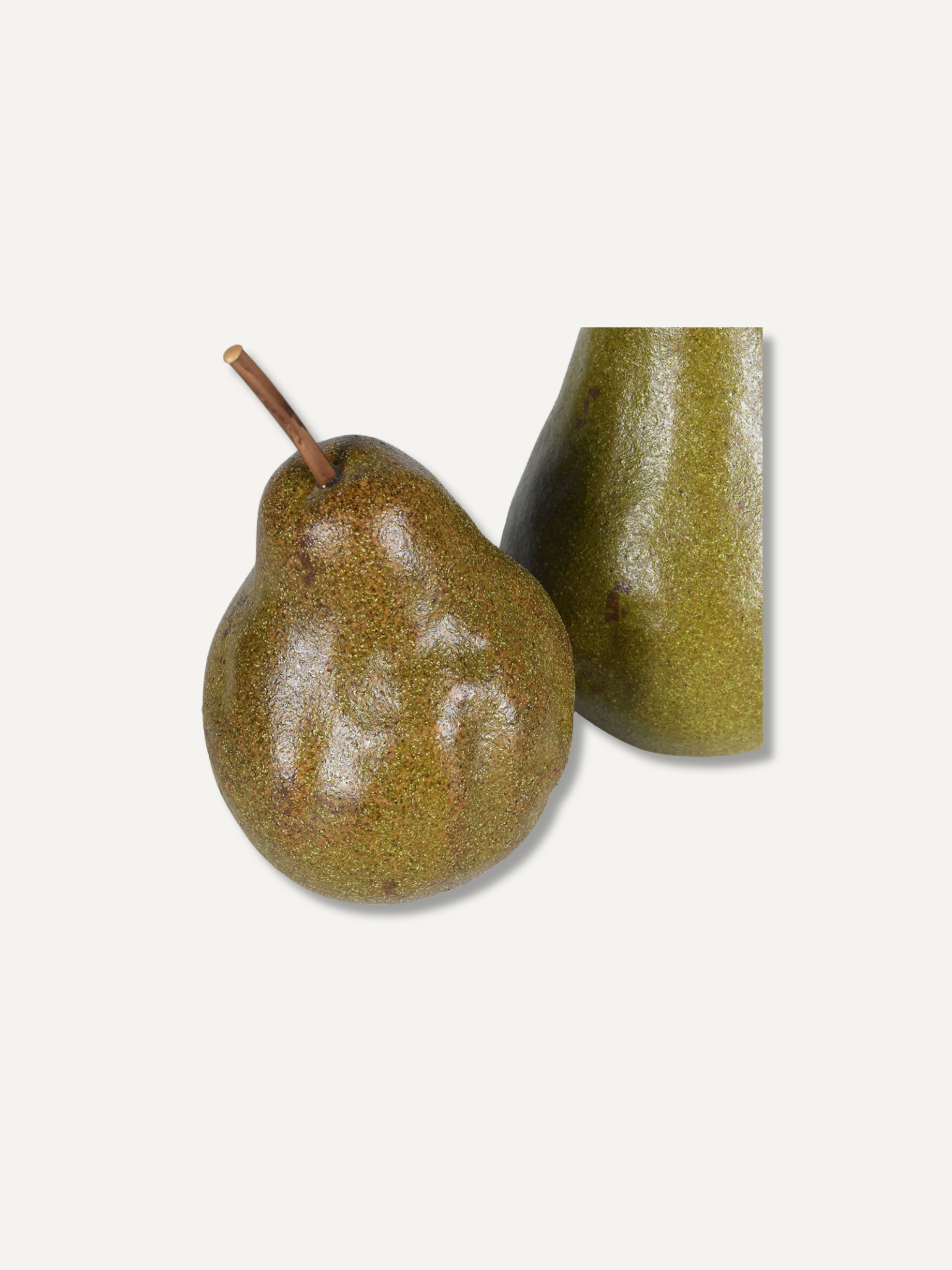 A ripe brownish-green pear with a short stem next to a close-up side view of its textured skin, set against a solid off-white background.