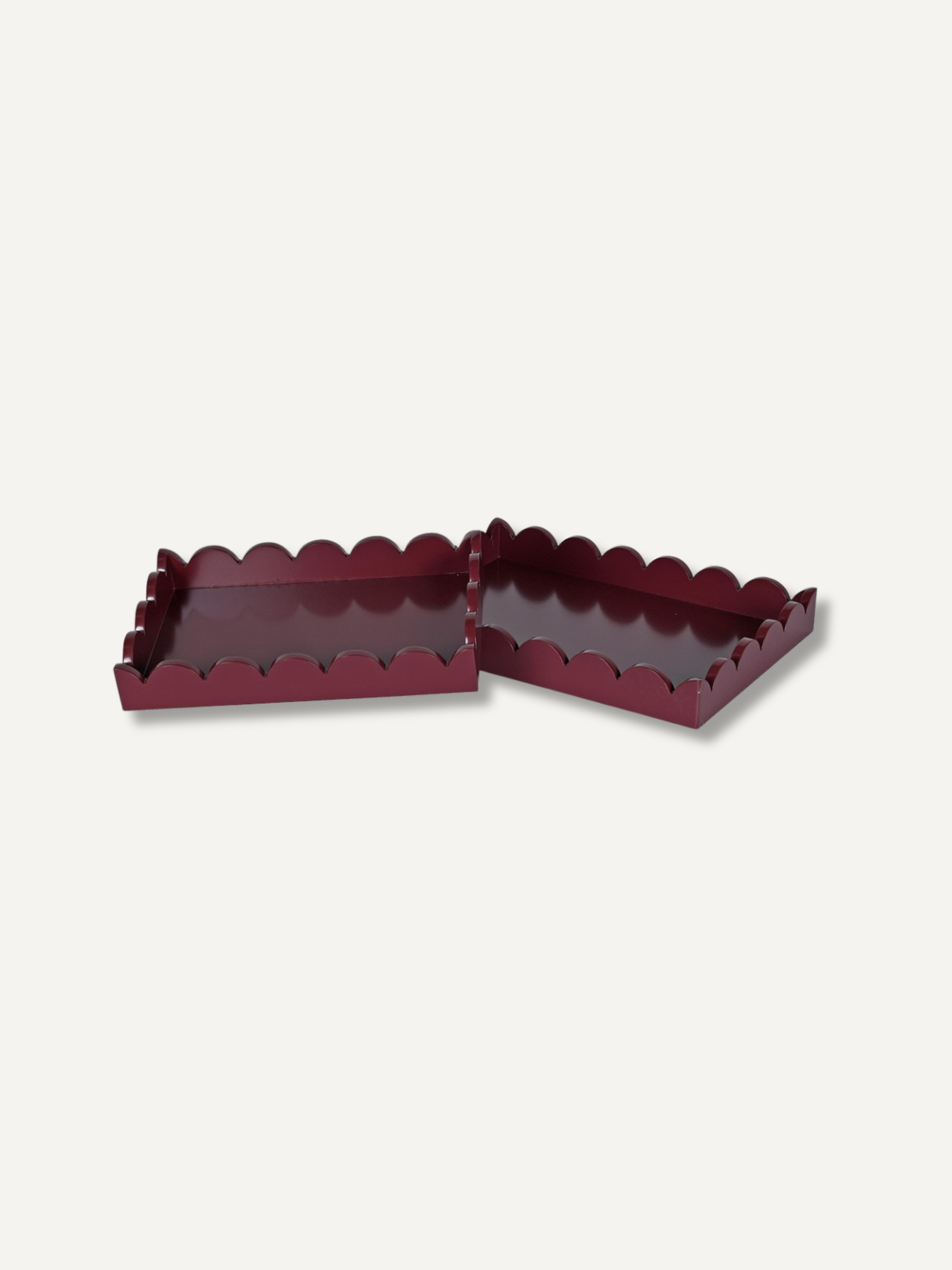 Two small rectangular tray accessories with scalloped edges in a deep burgundy colour, shown on a plain light gray background.