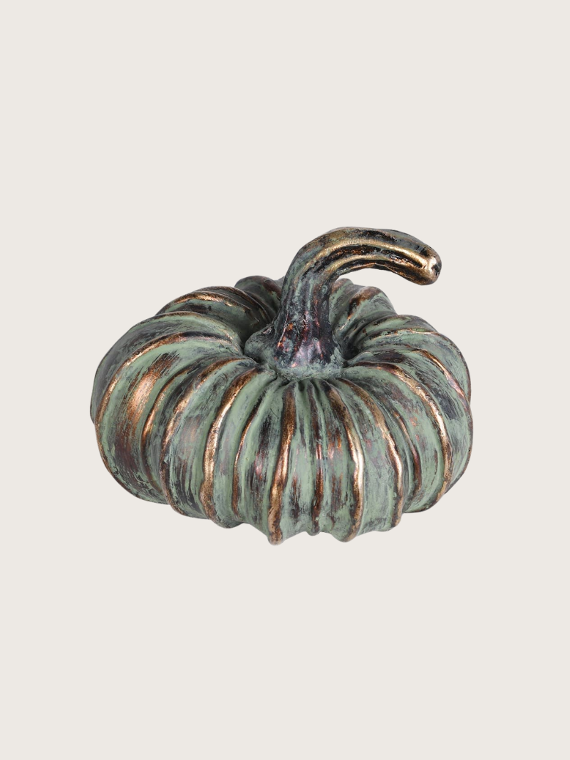 Decorative pumpkin with a textured surface on a light gray background