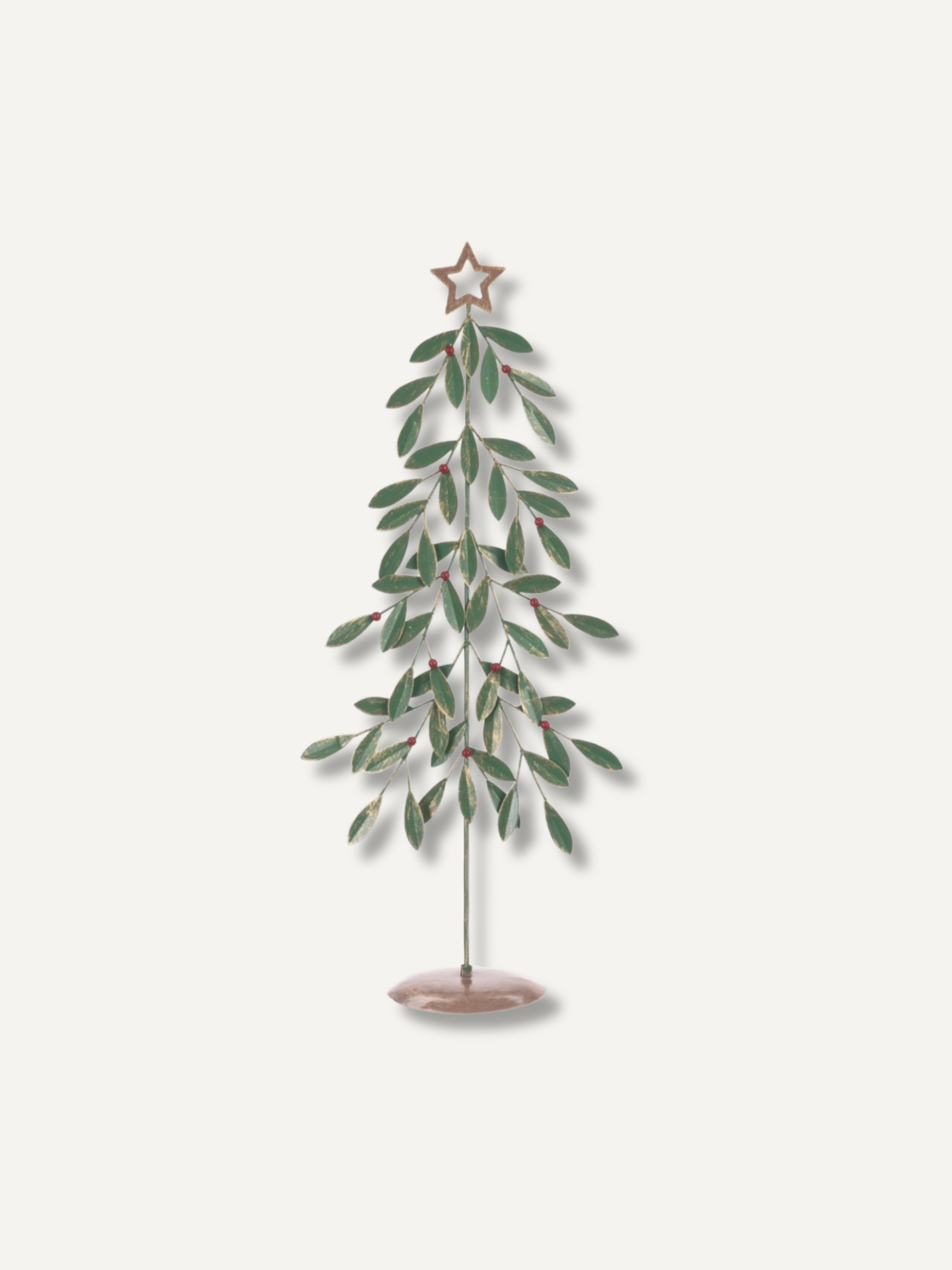 A decorative metal tree ornament with green leaves, a star topper, and a round base, shown against a plain light background.