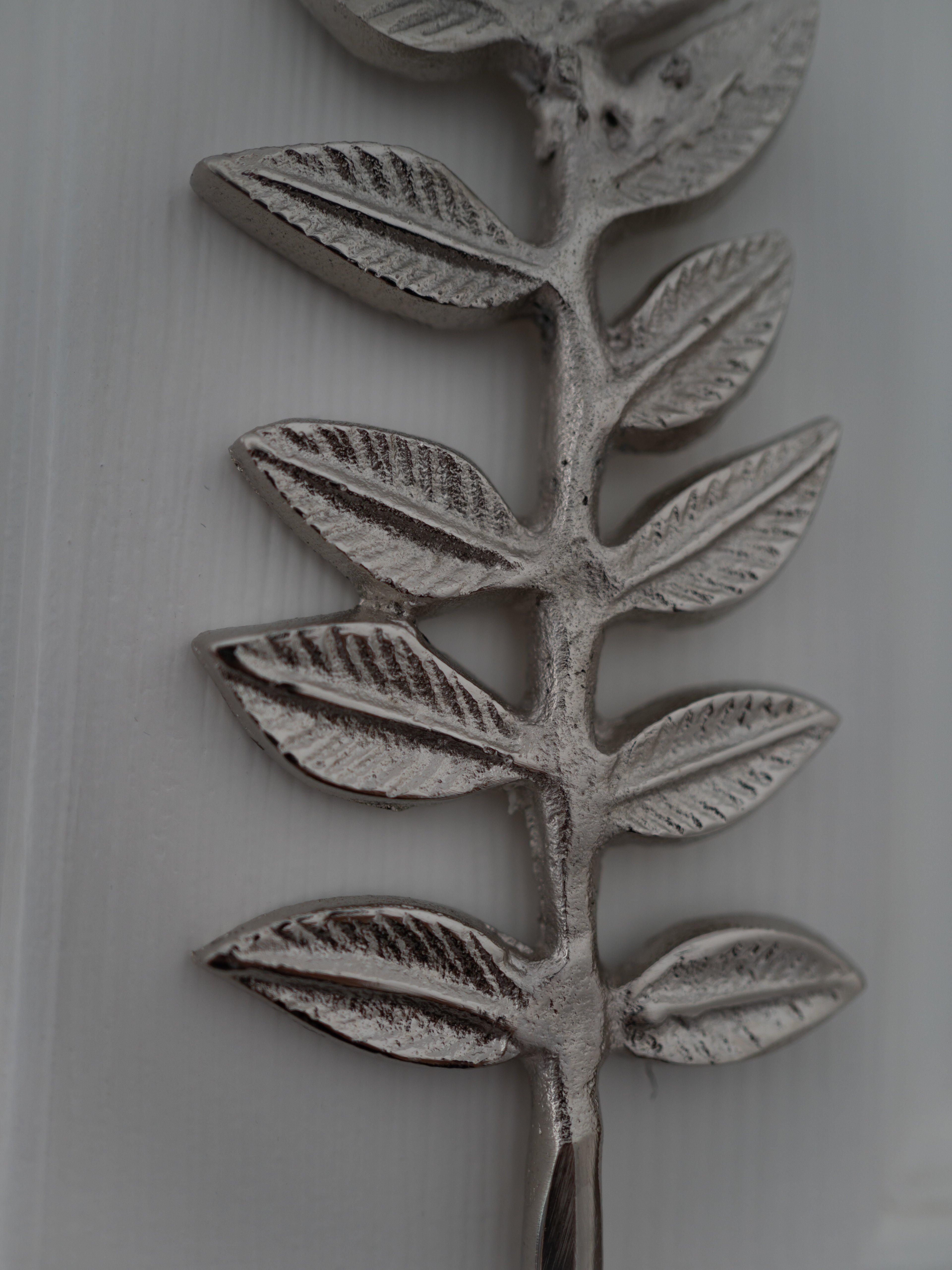 Decorative leaf pattern on a ceramic plate with a white background