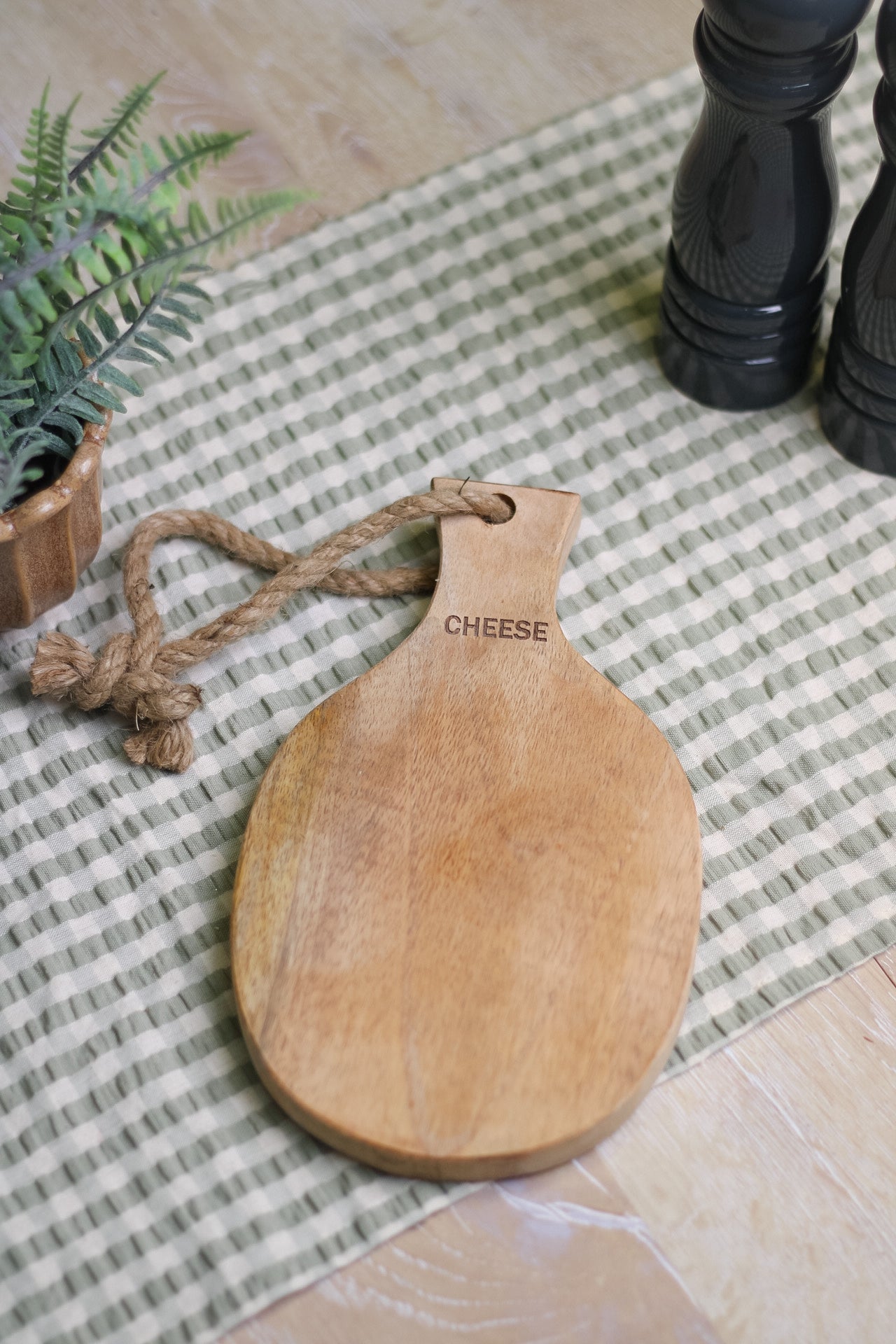 wooden chopping board with twine handle detail