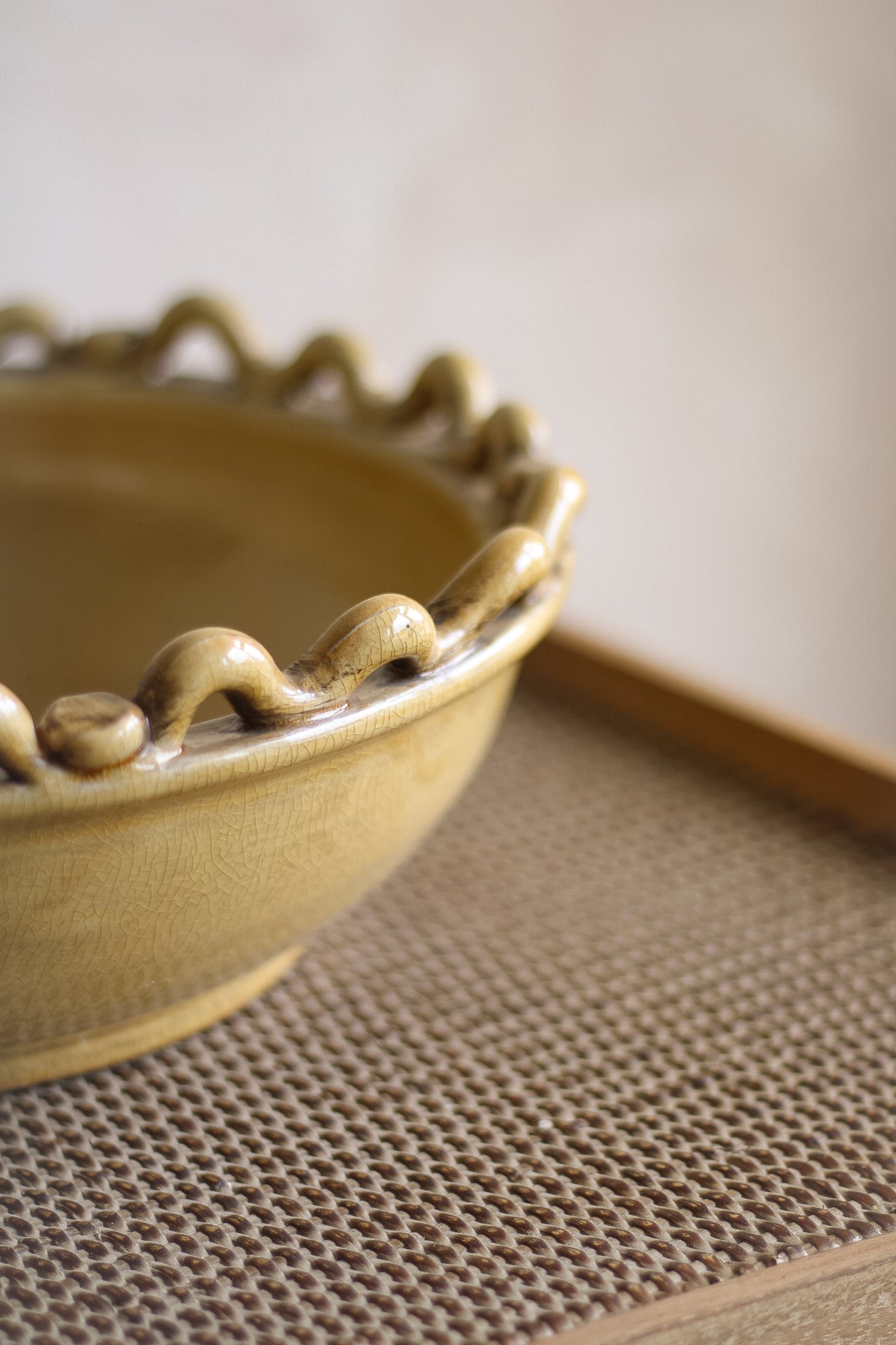 Ceramic bowl with decorative edge on a textured surface