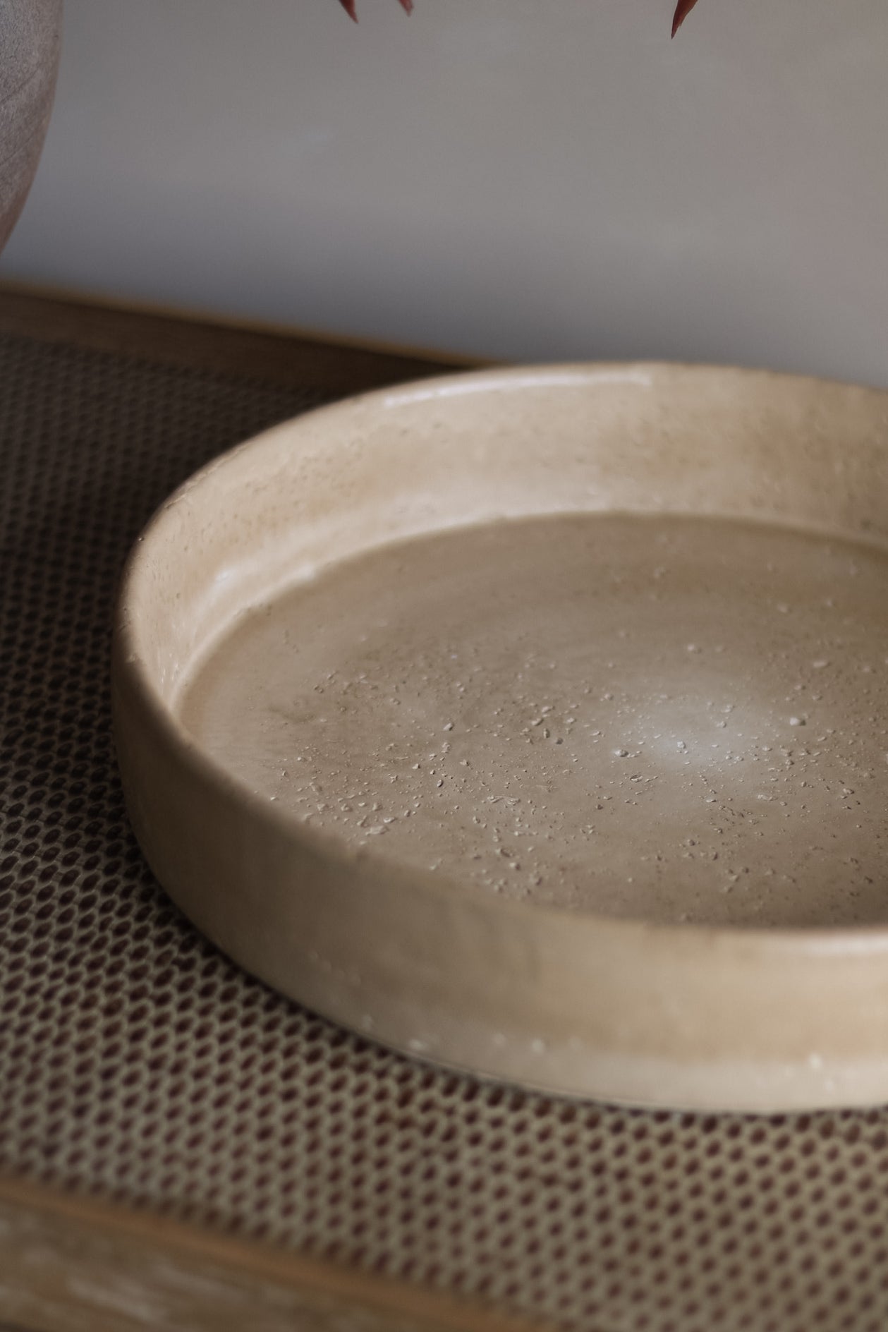Beige ceramic tray on a textured surface