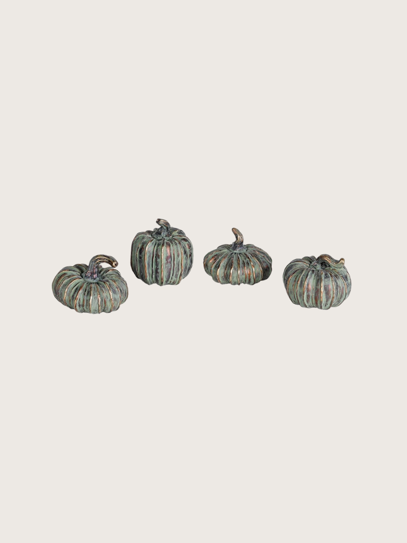 Four decorative pumpkins on a light gray background