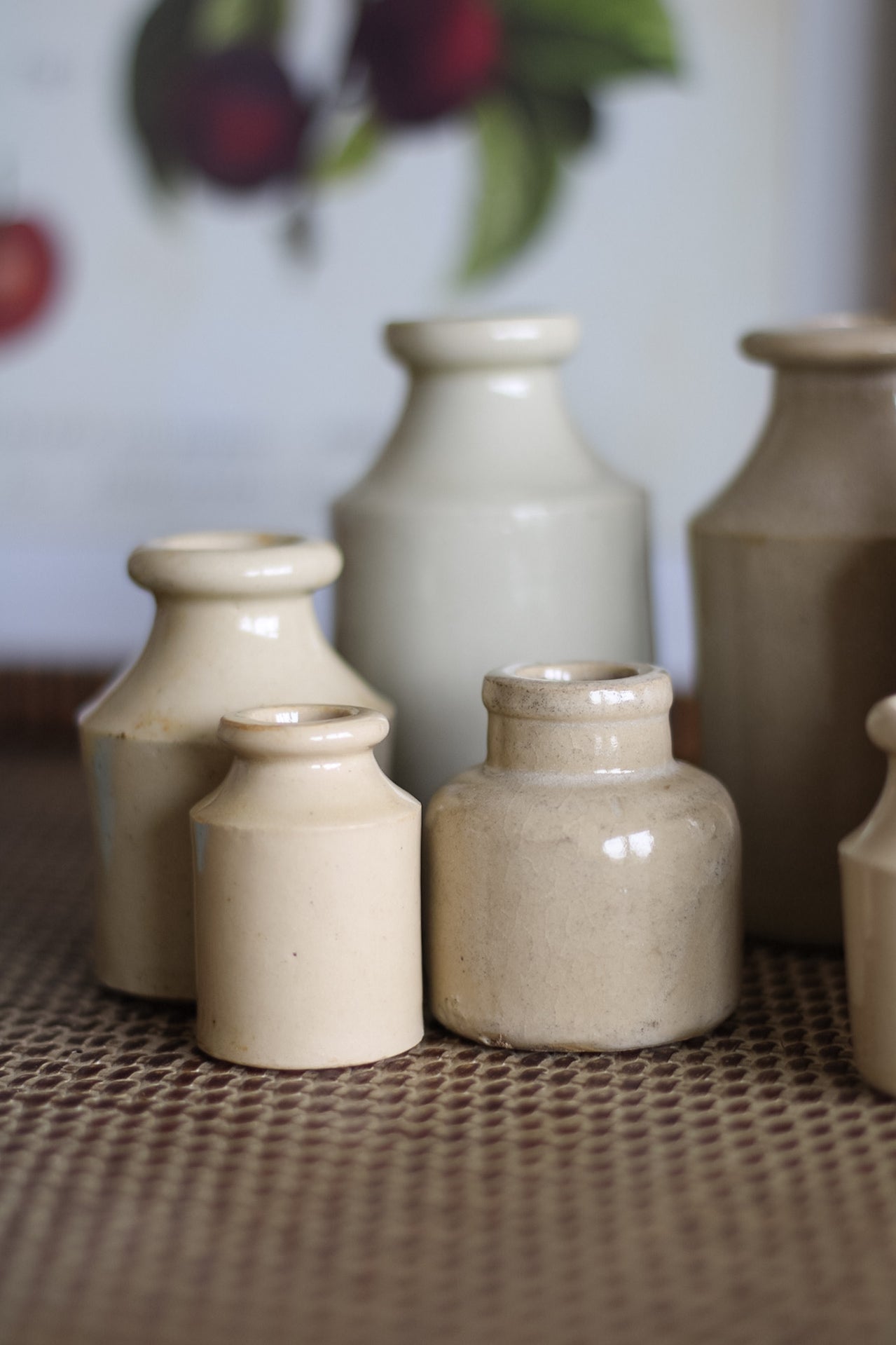 Set of ceramic bottles on a textured surface with a blurred background