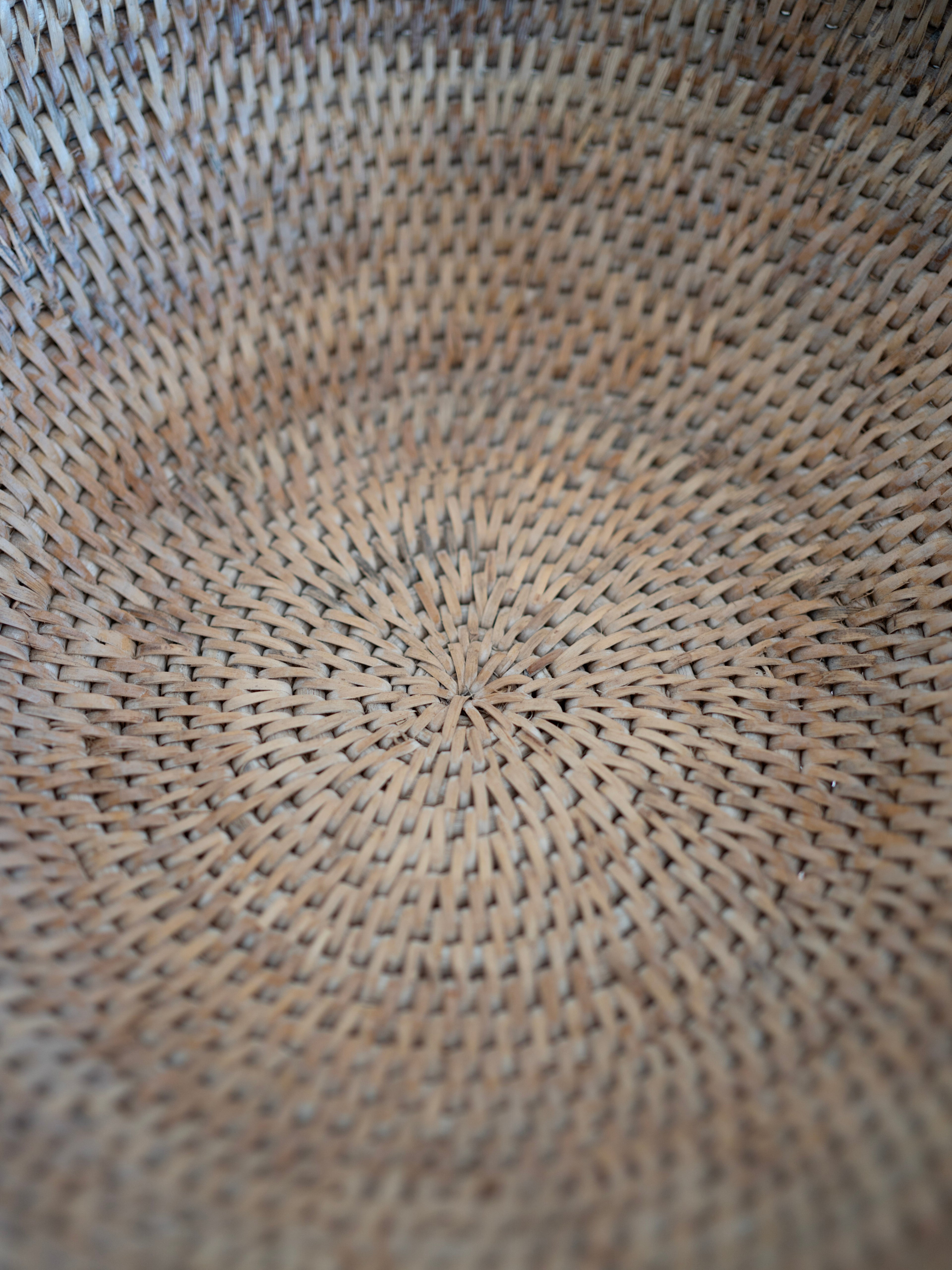 Close-up of a woven rattan pedestal fruit bowl texture