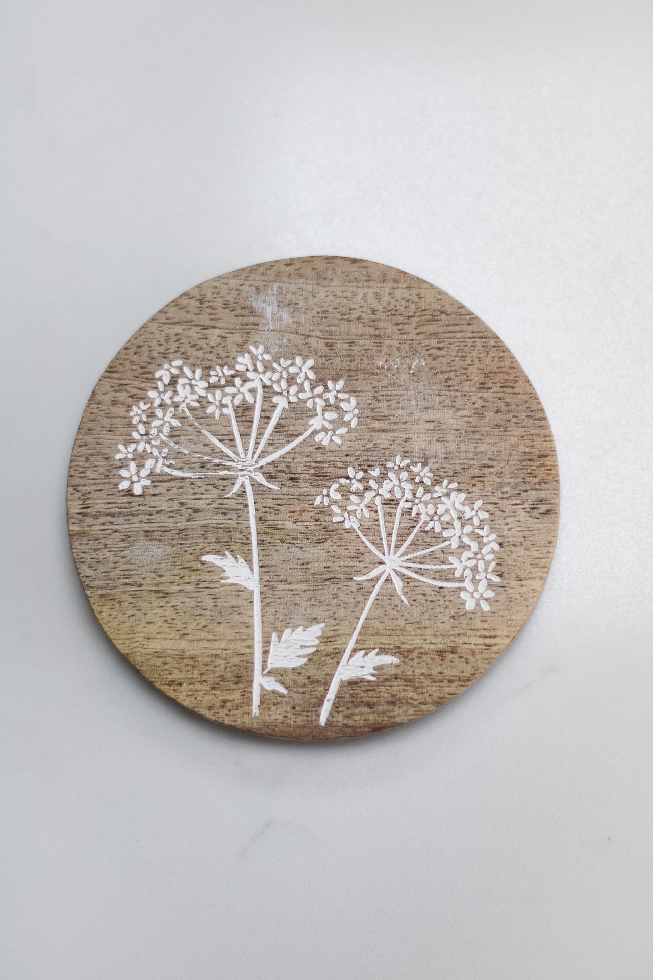 single wooden coaster with etched flower detail