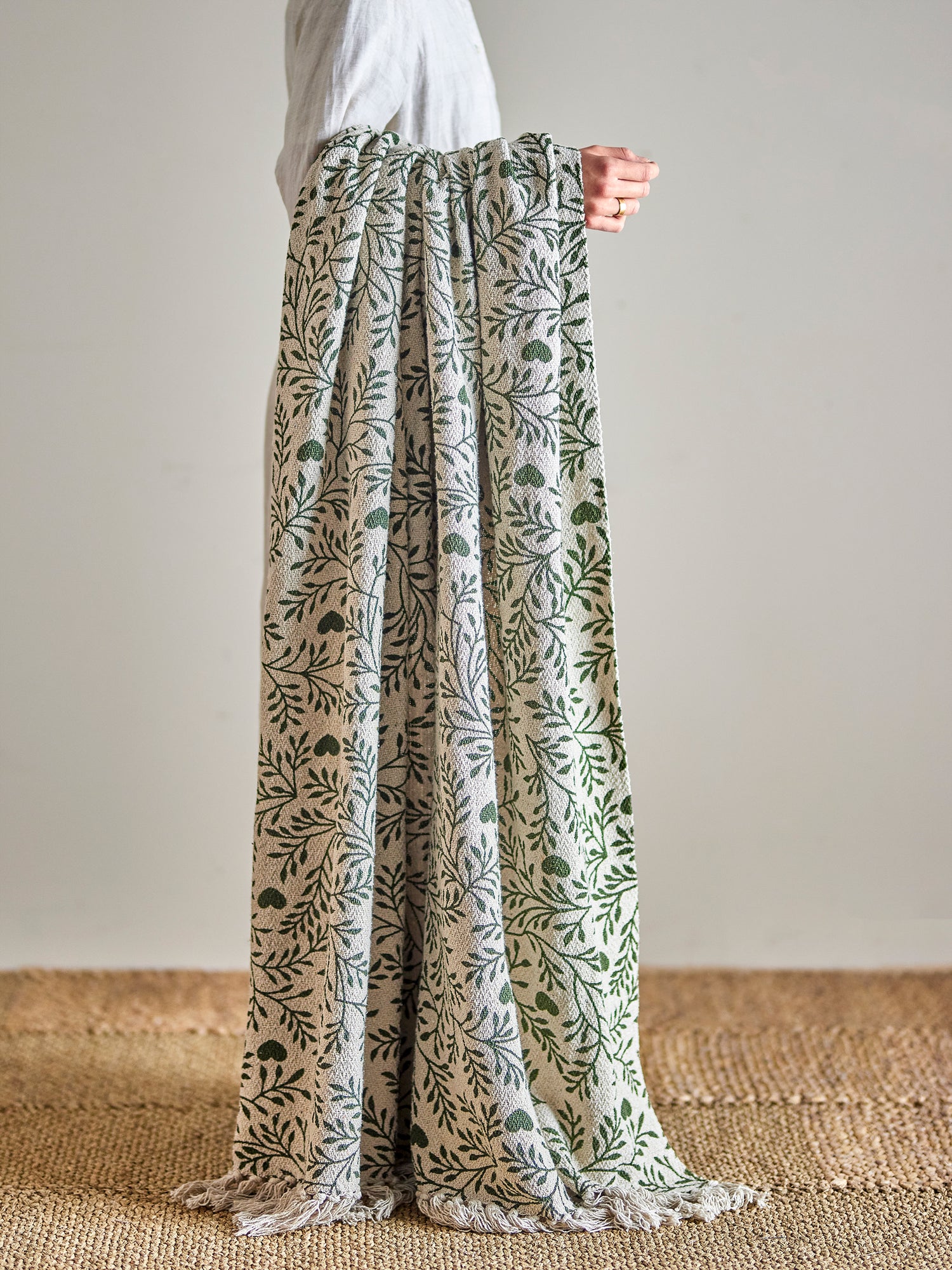 off white throw with moss green hearts and leaves design