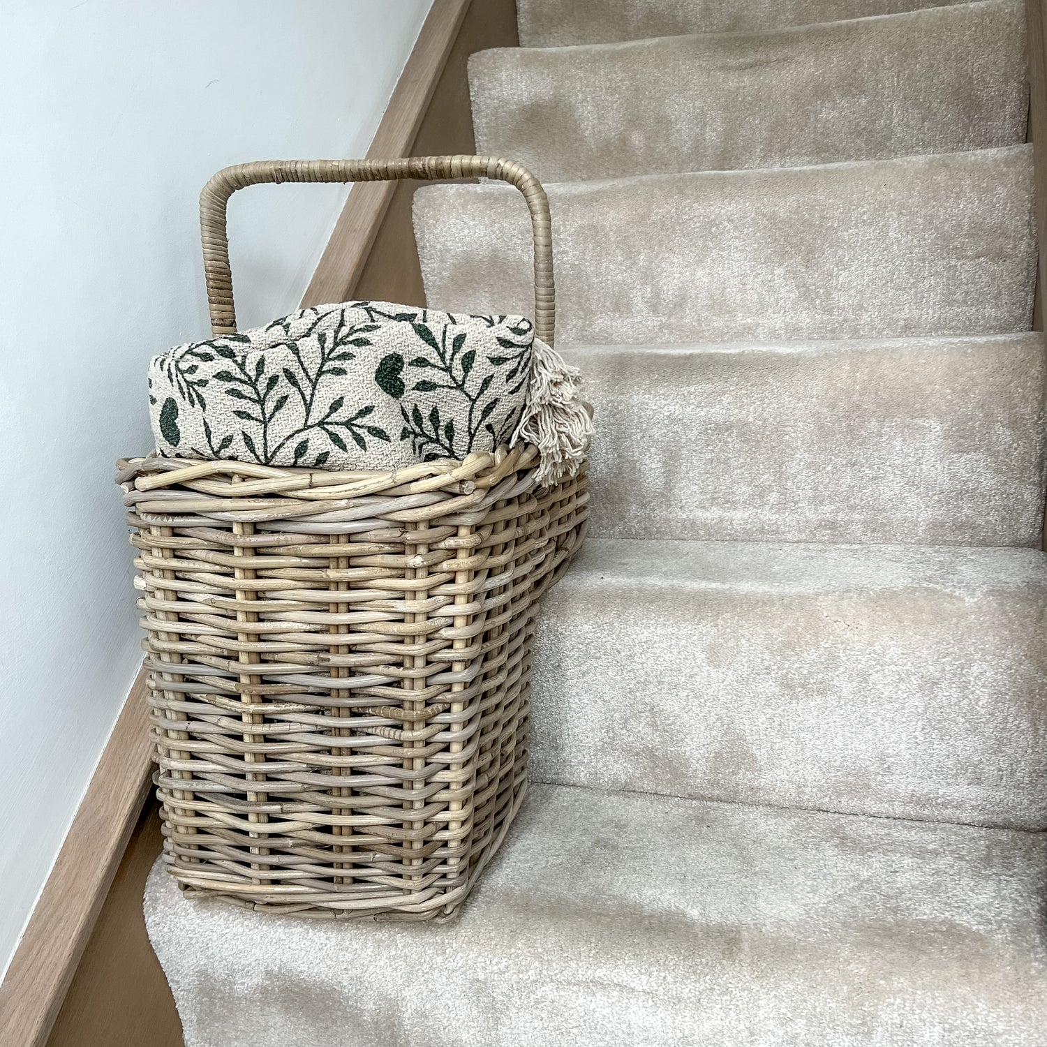 wicker basket on stairs with throw inside