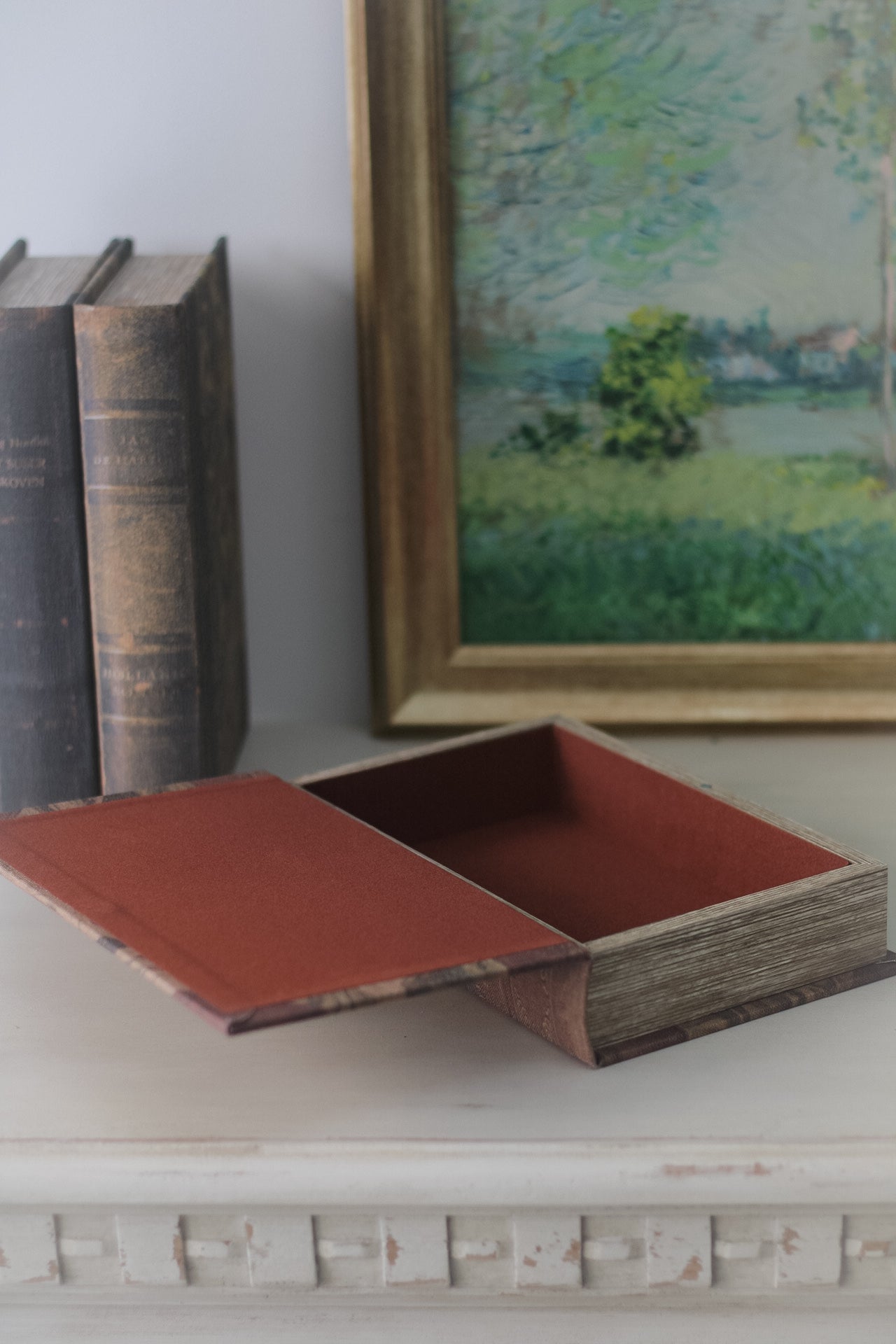 vintage inspired storage book boxes shown open with deep red inner. Perfect for storing remote controls on coffee table.