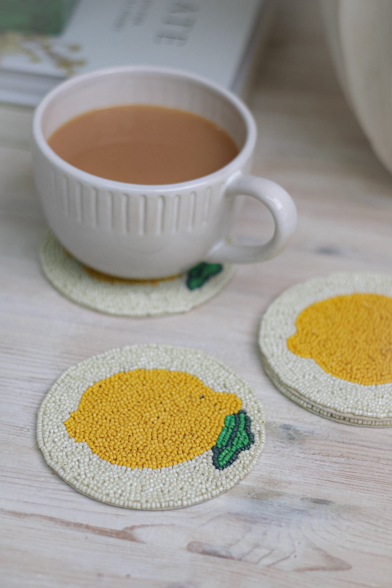lemon beaded patterned coaster for keeping coffee tables free for marks and looking elegant