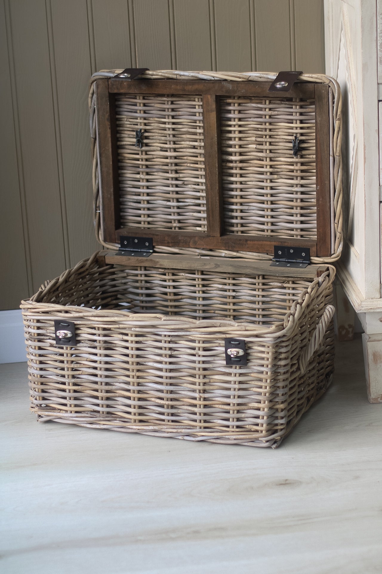 open rattan storage trunk with wooden base