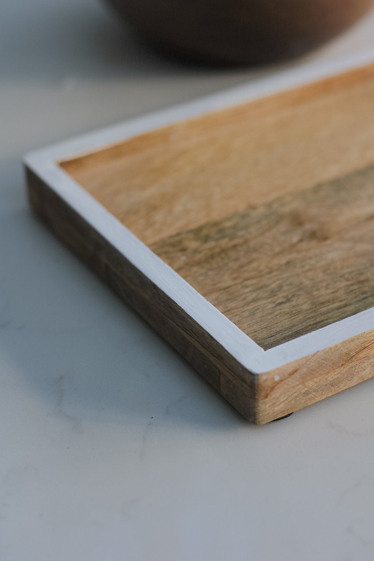 up close shot of white edge detail of small mango wood tray