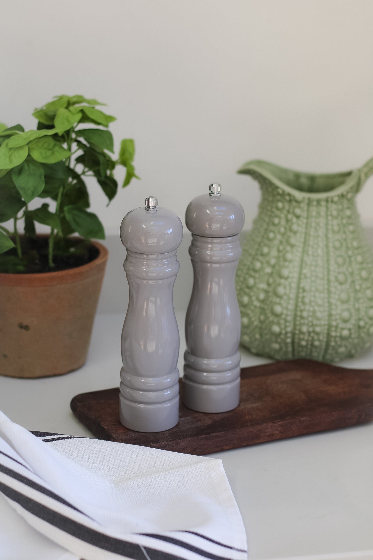soft grey salt and pepper grinders for timeless kitchen decor