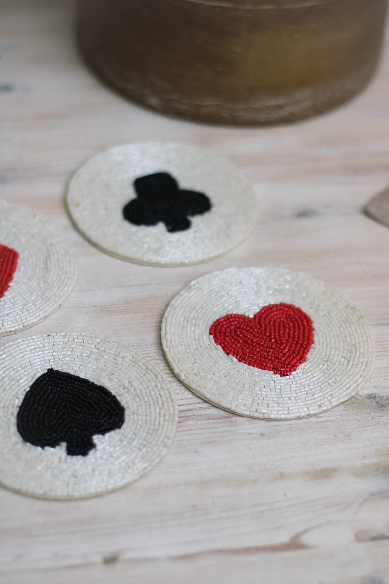 up close of beaded suit of cards coasters