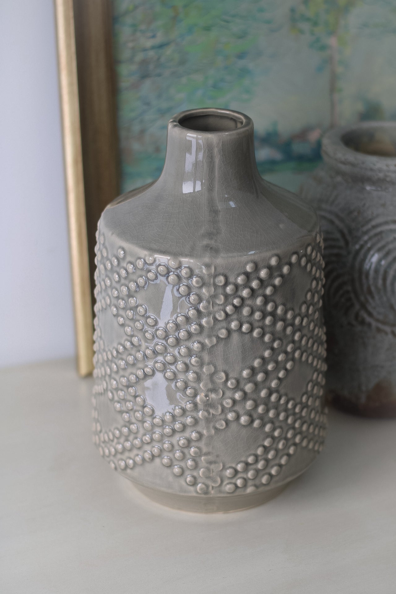 up close of grey ceramic dotty vase