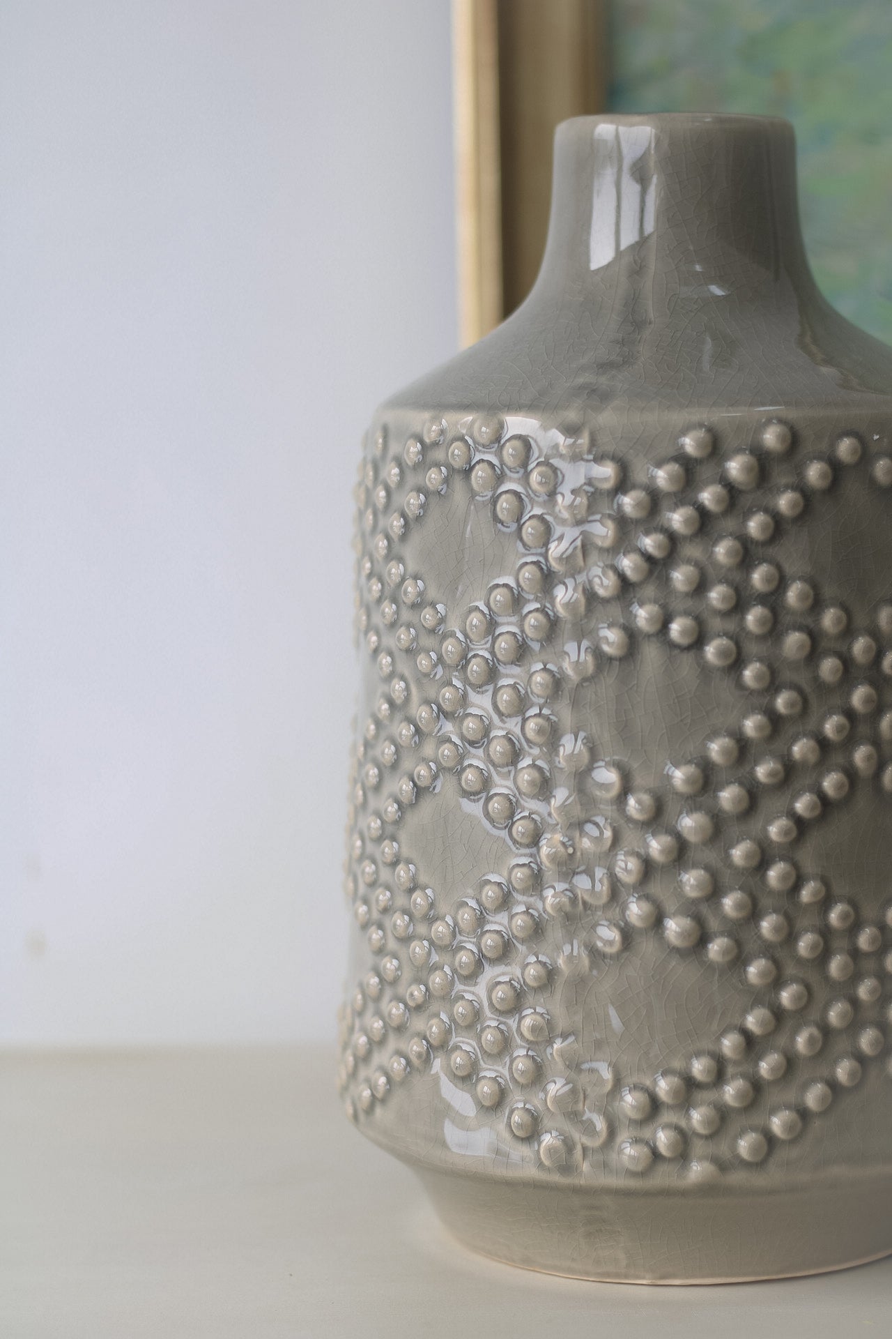 up close of grey ceramic dotty vase