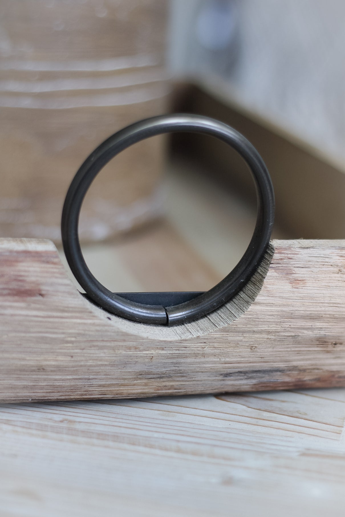 up close of metal loop handle of wooden tray