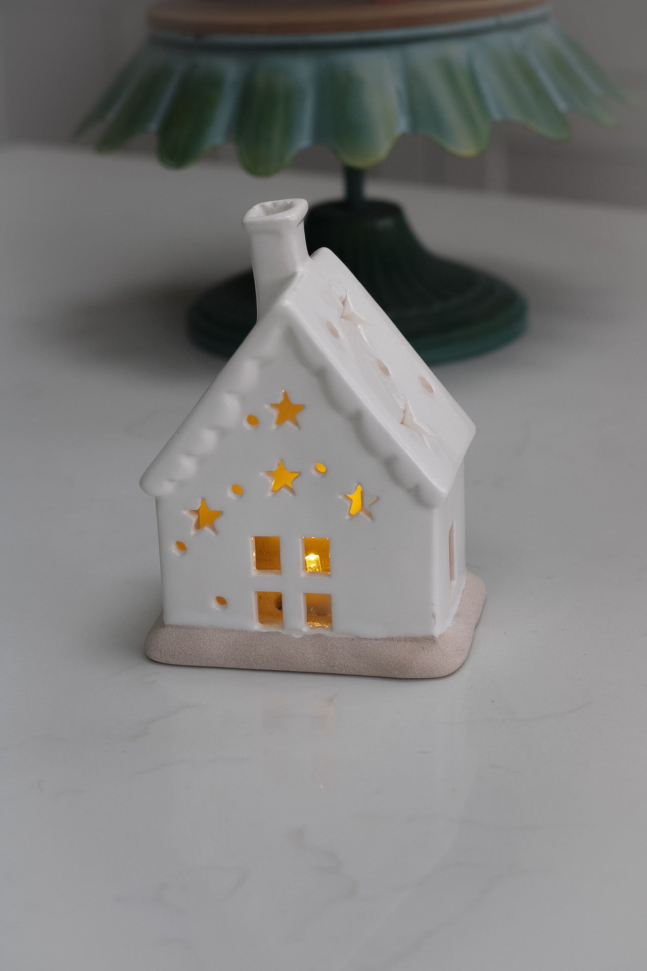 white ceramic house with star cut outs