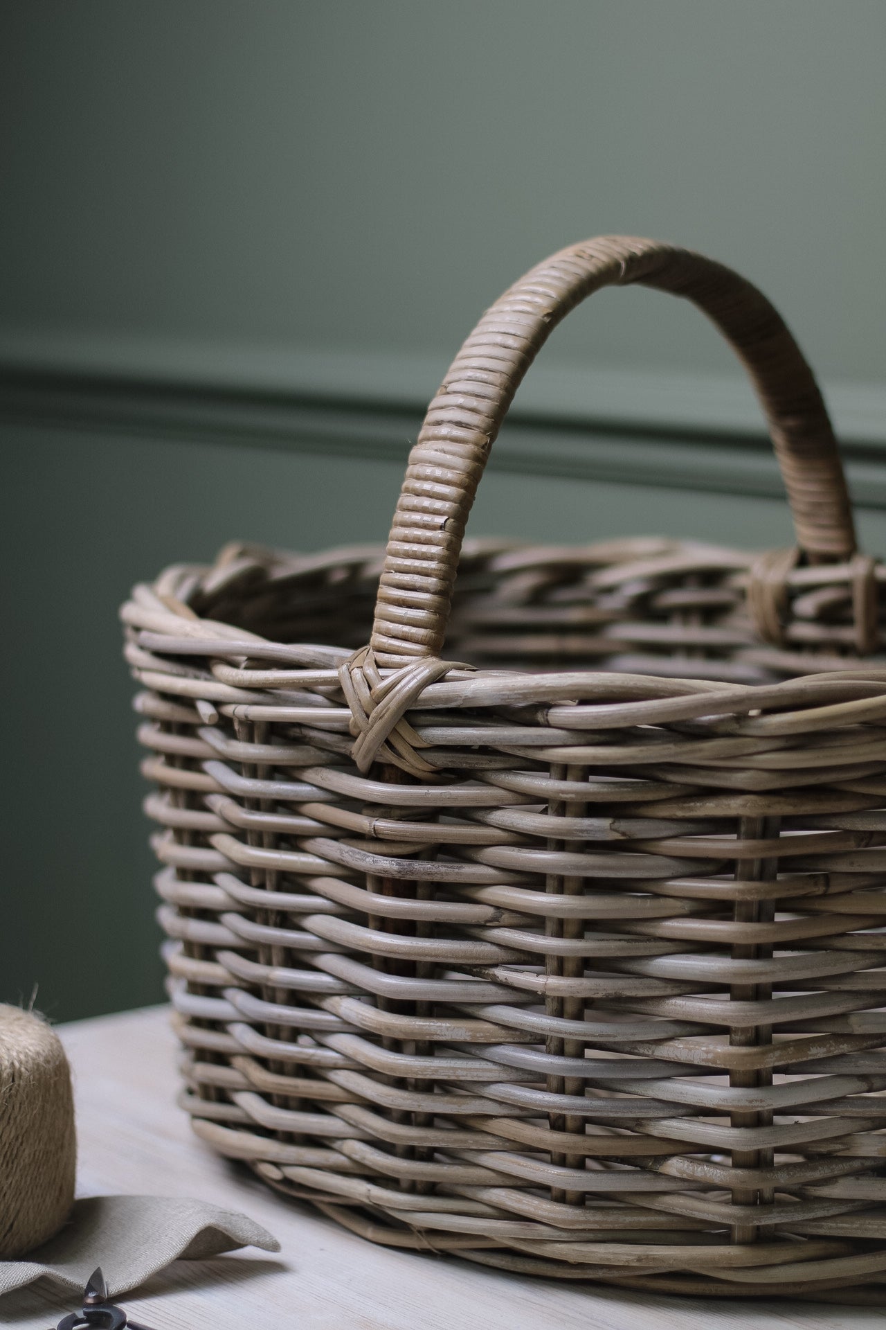 up close of grey washed storage basket with ribbed handle