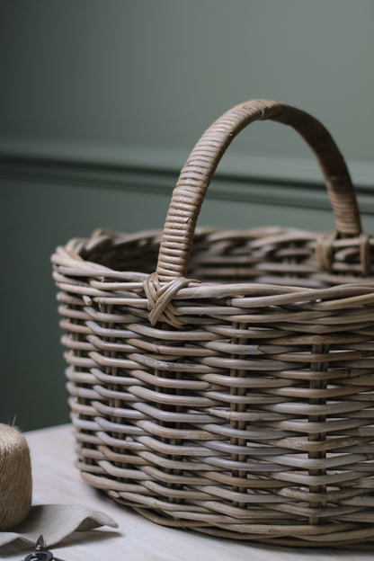 up close of grey washed storage basket with ribbed handle