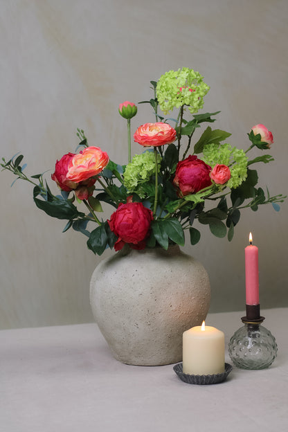 stone vase filled with faux peonies and eucalyptus stems for home decor