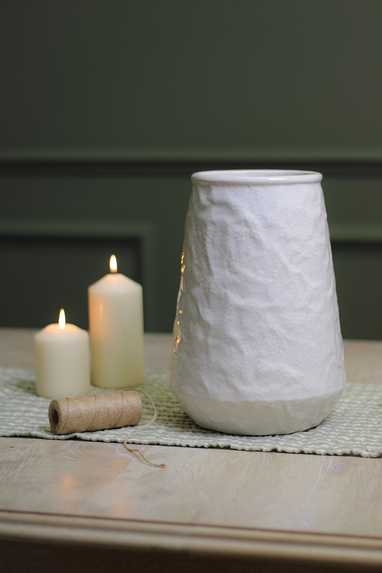 off-white textured vase with candles for home decor