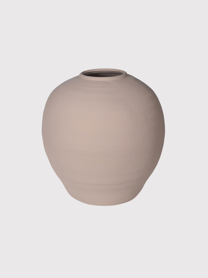 Beige terracotta vase on a light gray background