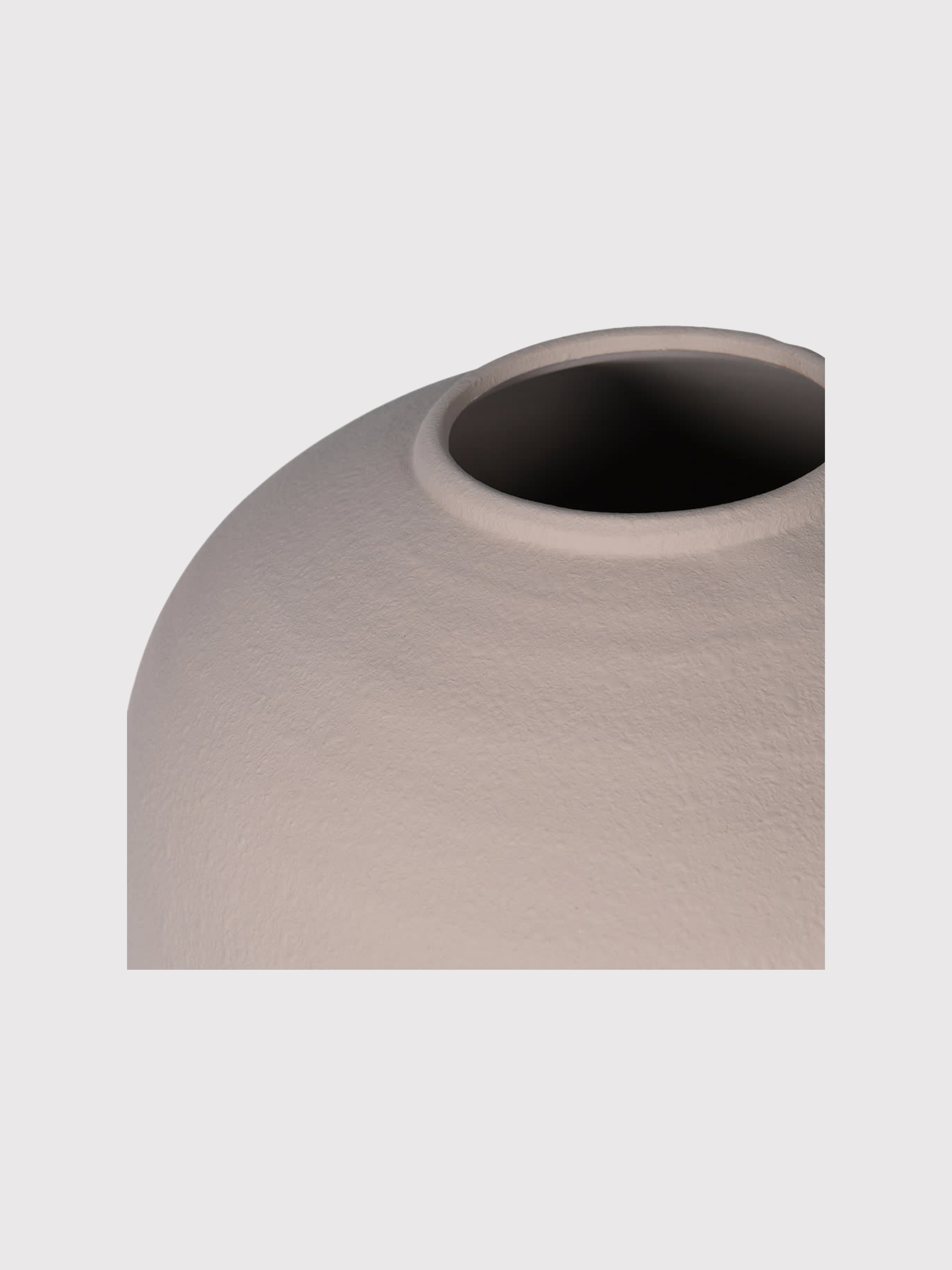 Almond terracotta vase with a textured surface on a light gray background