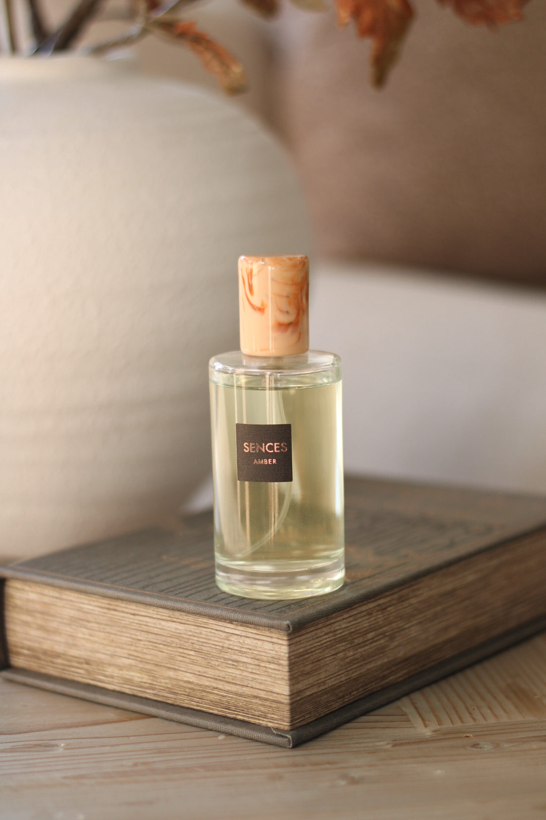Amber Sences room spray on a coffee table book