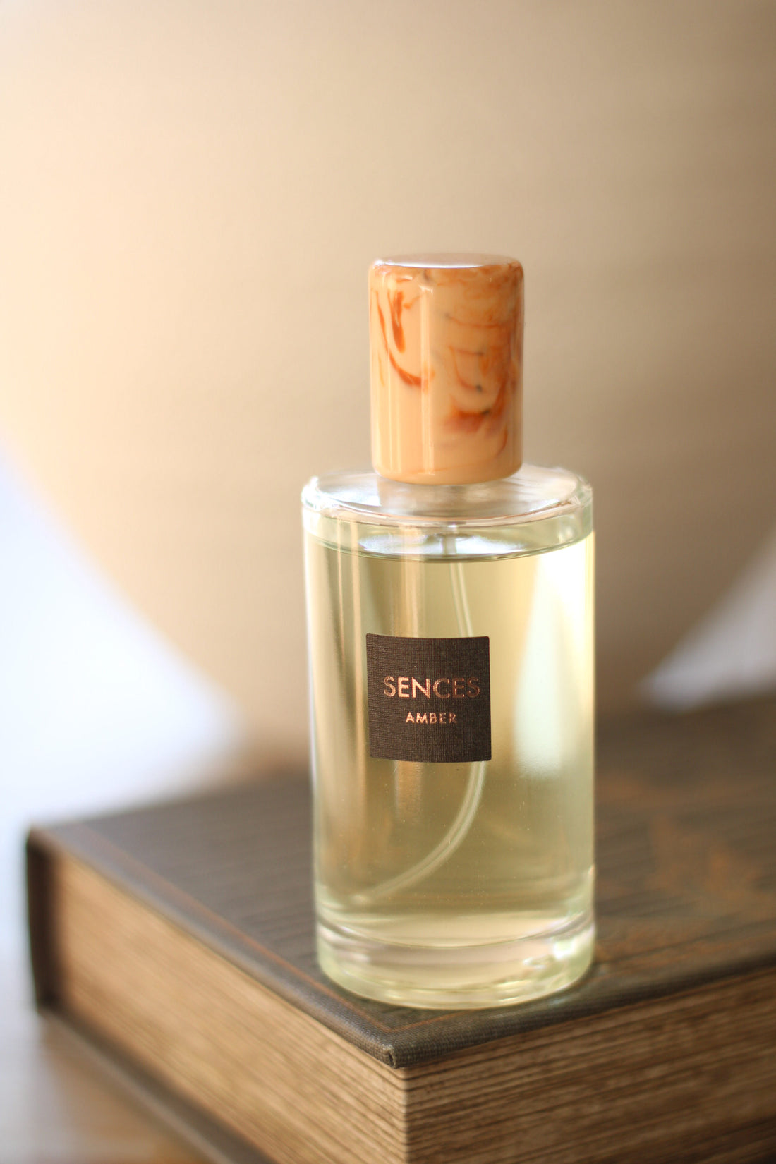 Amber sences room spray bottle on coffee table book