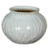 White ceramic vase with ribbed texture on a white background
