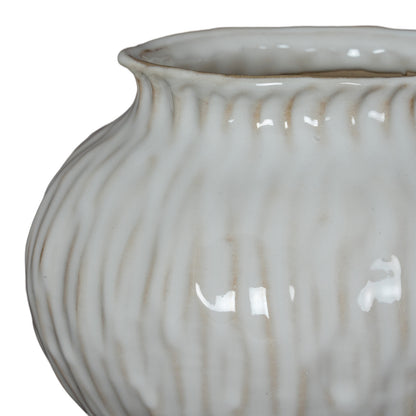 Close-up of a textured ceramic vase on a white background