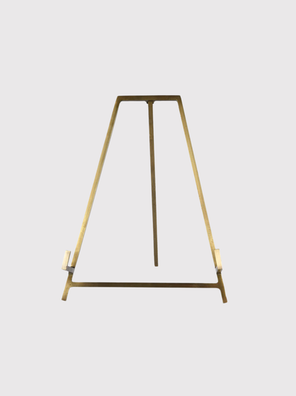 Gold metal antique brass easel on a white background