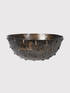 Decorative bowl with textured surface and small studs on a light gray background