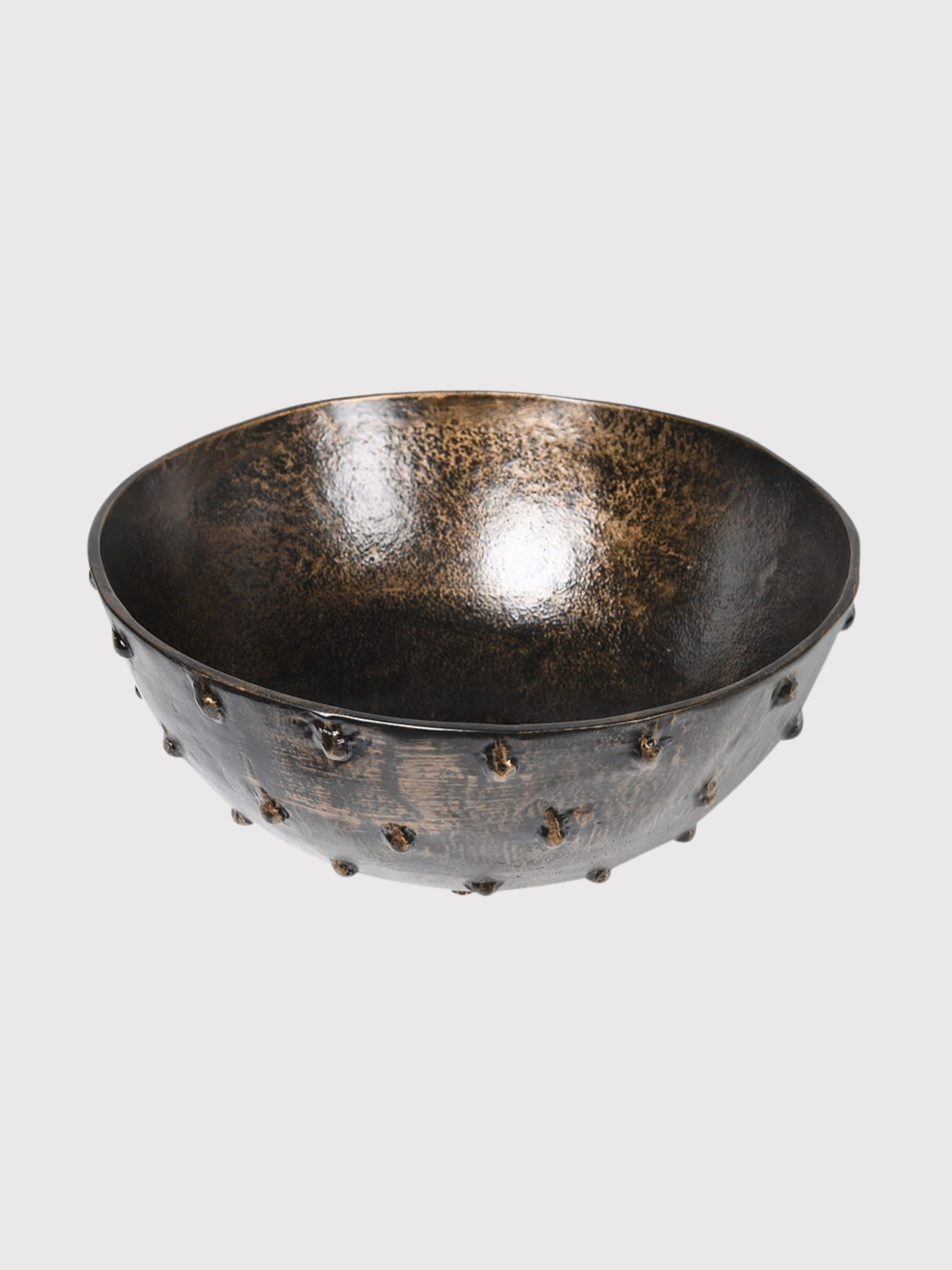 Decorative black bowl with textured surface on a light gray background