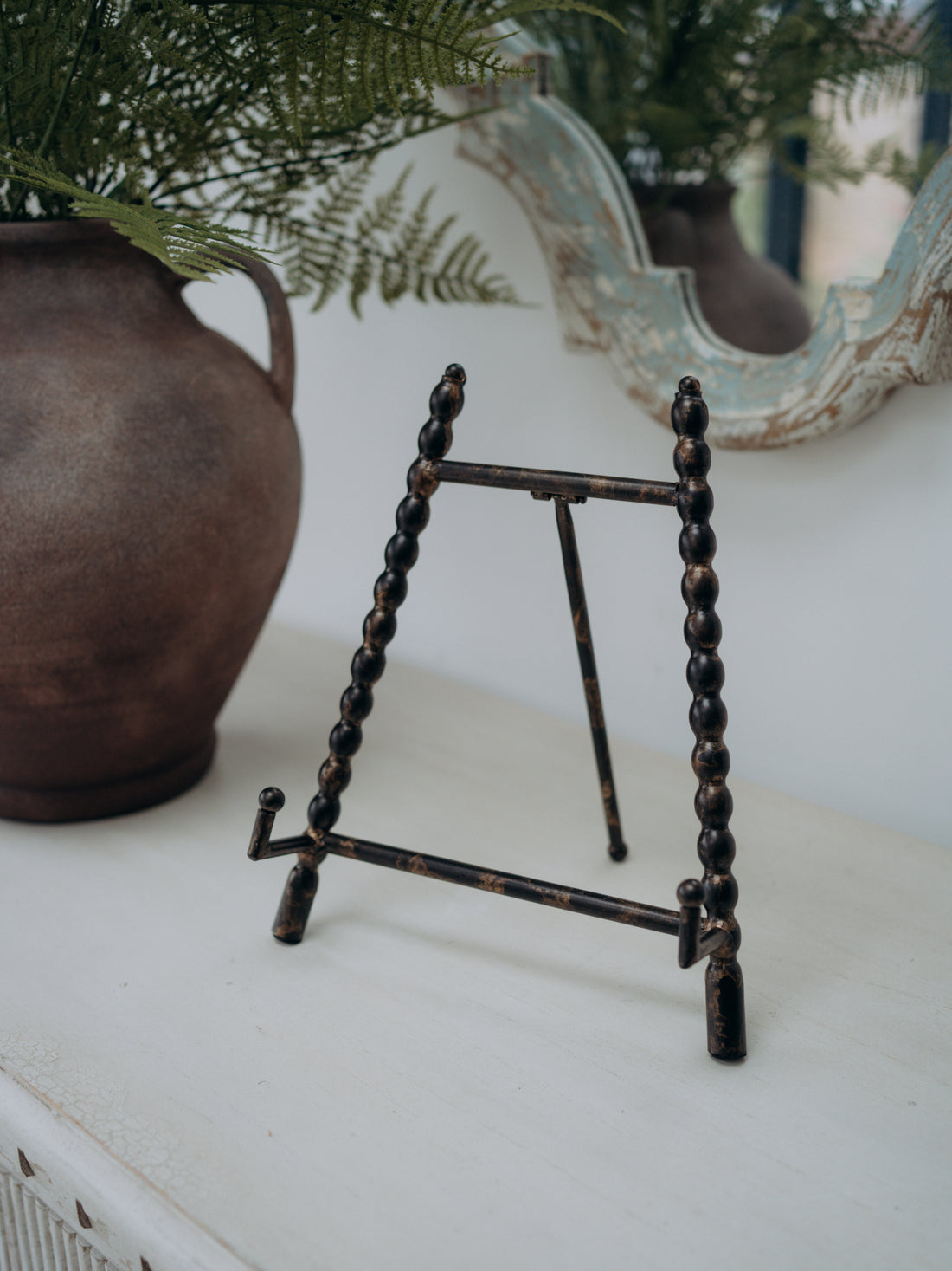 Antique Gold Beaded Mini Easel with rustic vase and faux ferns in the background