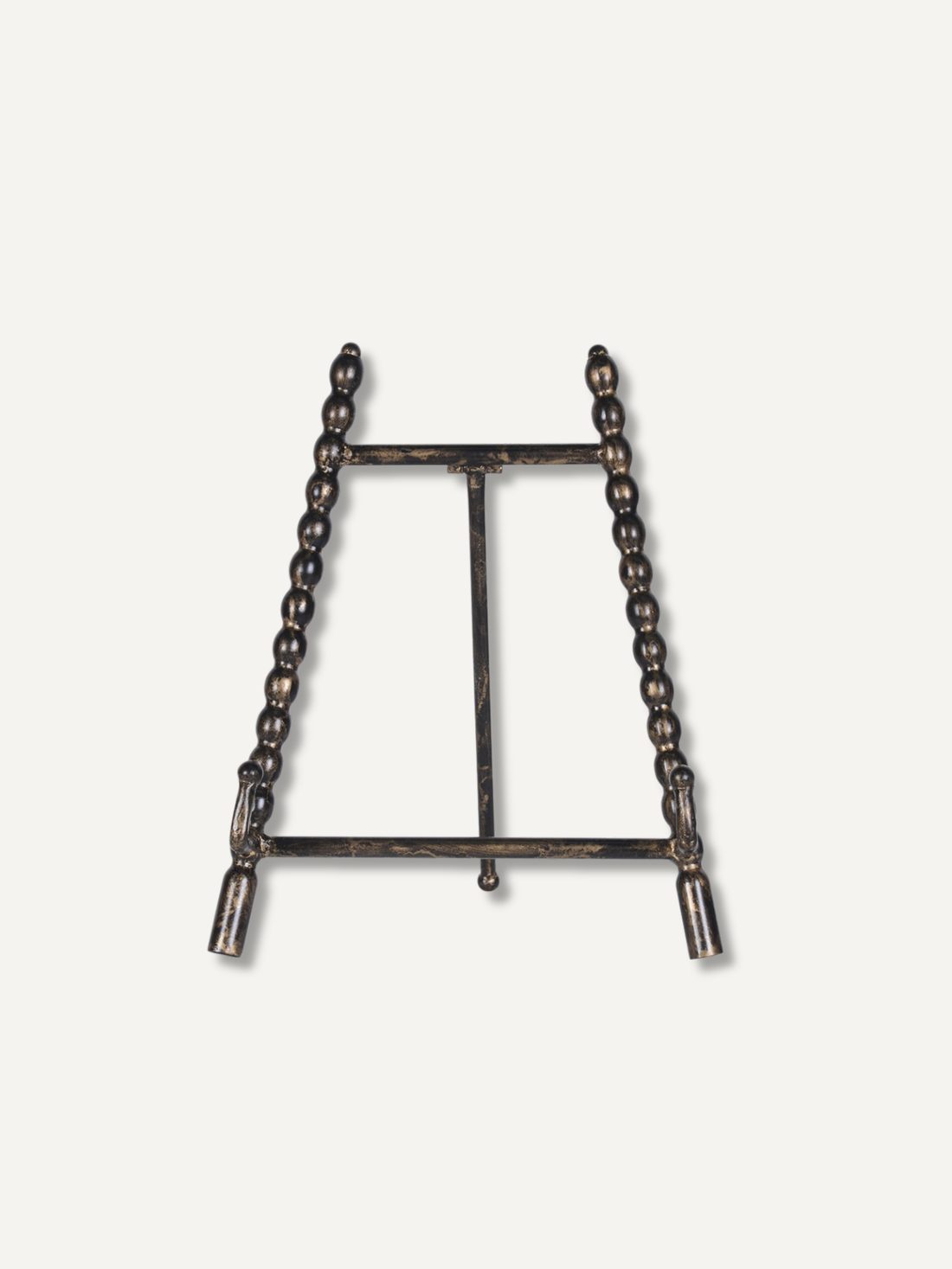 A dark metal tabletop easel stand with beaded vertical side supports and a central support bar, shown against a plain off-white background.