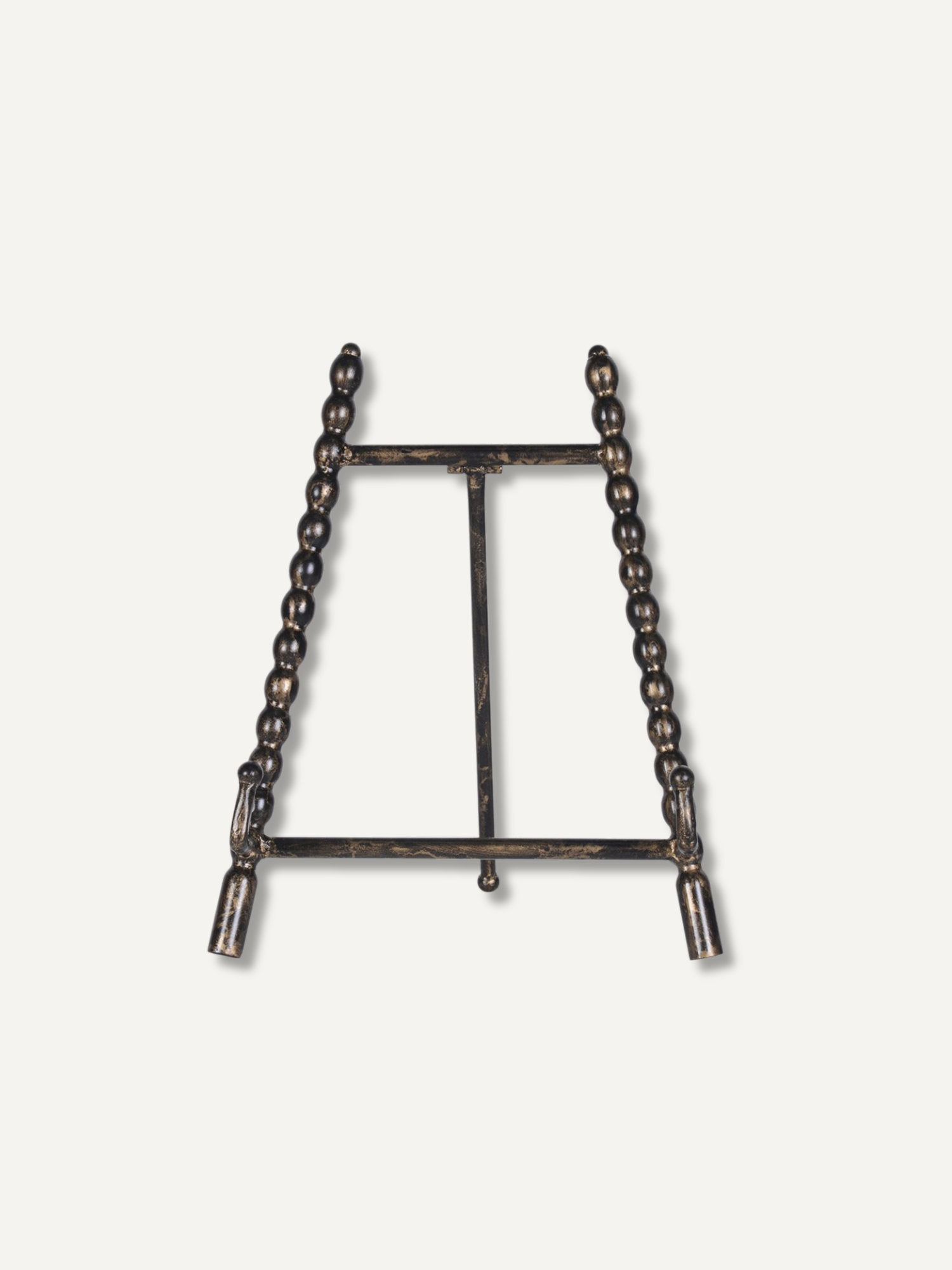 A dark metal tabletop easel stand with beaded vertical side supports and a central support bar, shown against a plain off-white background.