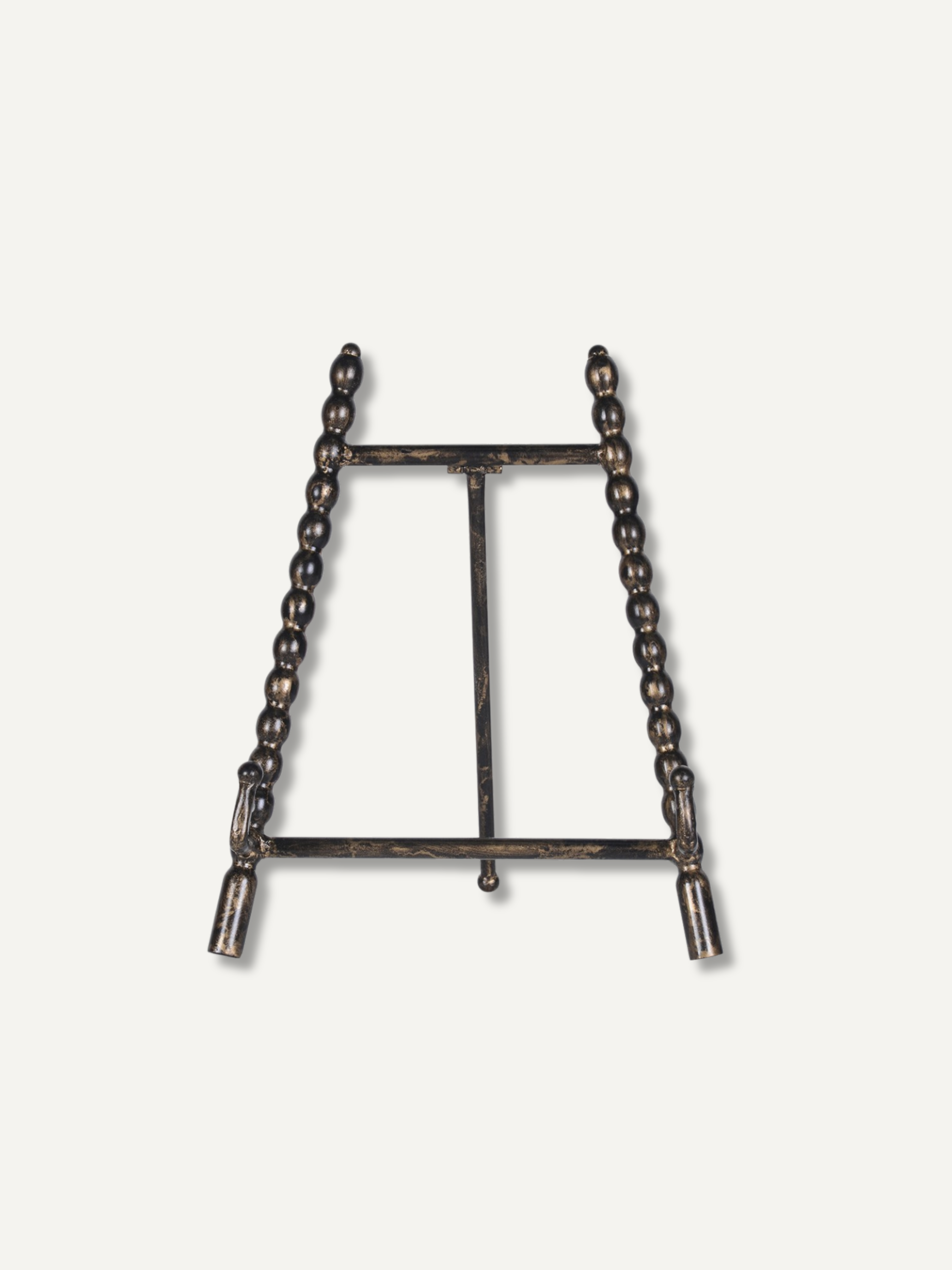 A dark metal tabletop easel stand with beaded vertical side supports and a central support bar, shown against a plain off-white background.