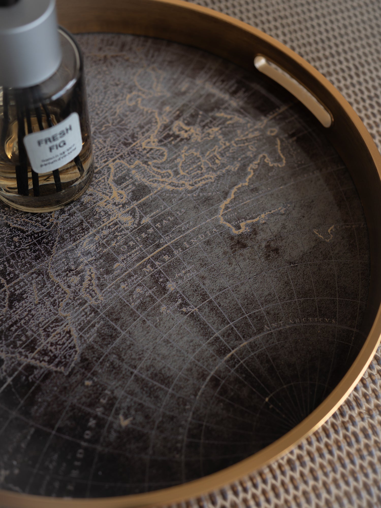Tray with world map design and a bottle of &