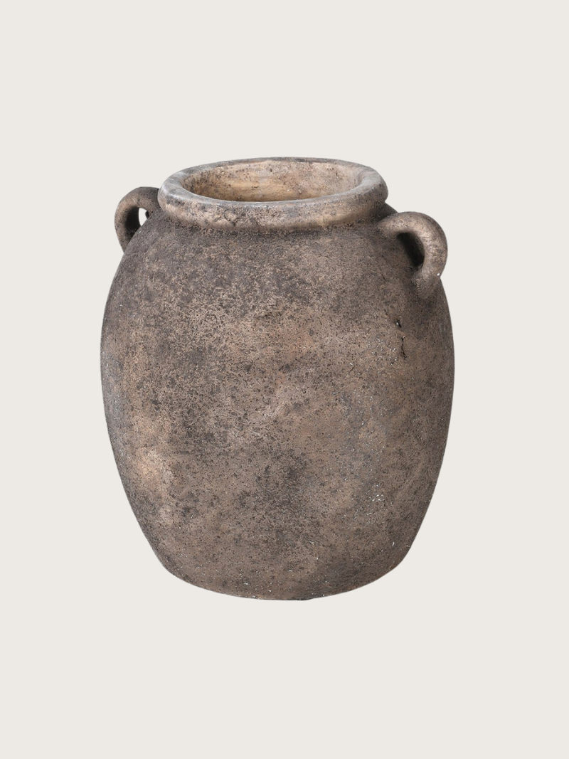 Vintage-style terracotta pot with two handles on a light gray background