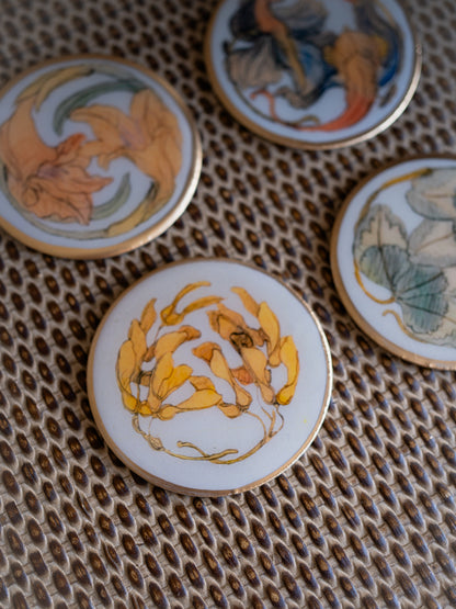 Decorative coasters with floral designs on a textured surface