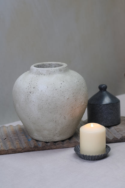pale grey stone vase with candle and marble jar