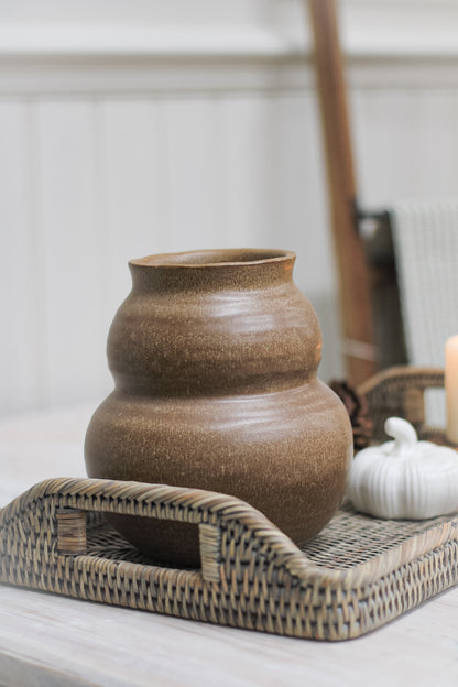 brown vase on rattan tray