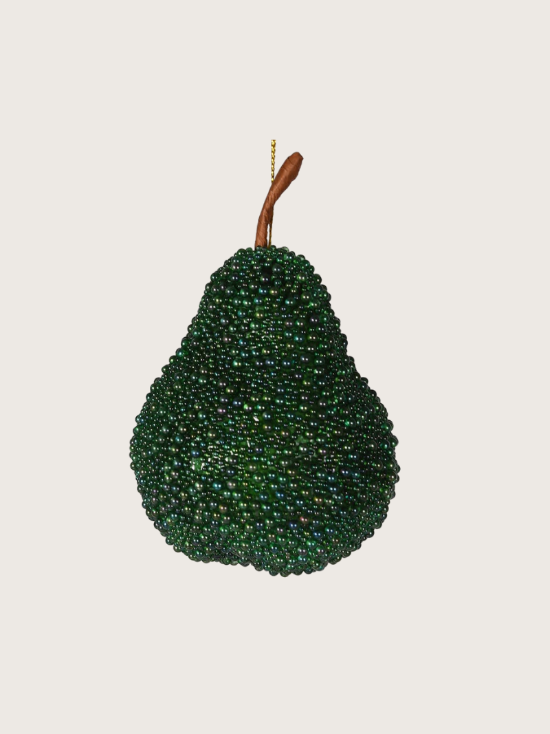 Decorative pear ornament made of green beads on a beige background