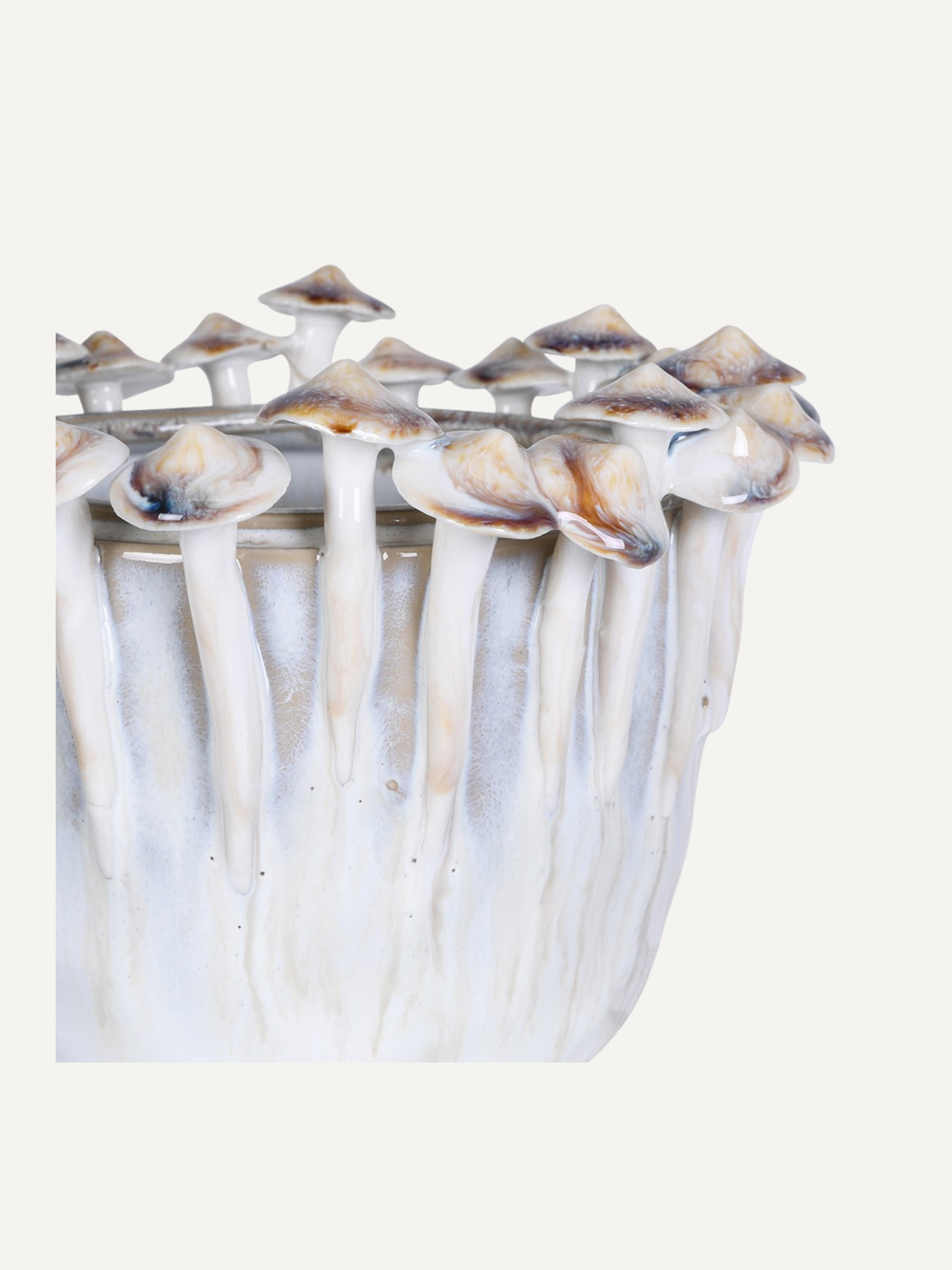Close-up of a ceramic vase with a unique mushroom design on a white background