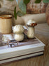 Decorative mushrooms on an open book with a blurred background
