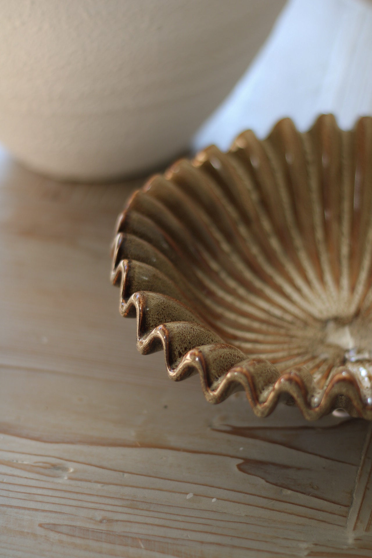 Ceramic bowl with textured edge on a wooden surface
